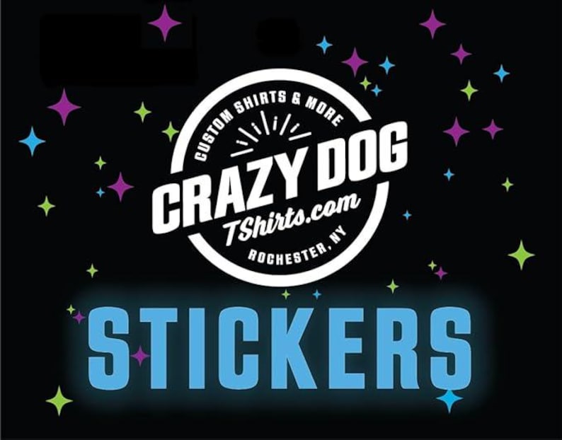 May include: Black background with colorful star shapes and the text "STICKERS" in light blue. A white circular logo in the center reads "CRAZY DOG TShirts.com ROCHESTER, NY" with the words "CUSTOM SHIRTS & MORE" around the logo.