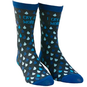 May include: A pair of blue and gray socks with a blue raindrop pattern and the text "I cry at work" on each sock.
