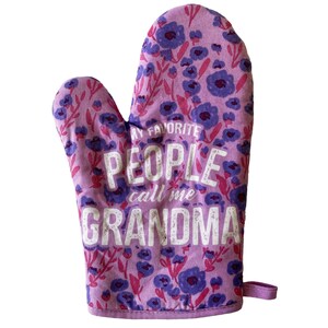 May include: A lavender oven mitt featuring a repeating pattern of dark blue flowers and pink stems. The text printed in white across the center reads: MY FAVORITE PEOPLE call me GRANDMA. The mitt includes a small fabric loop on the bottom right side.