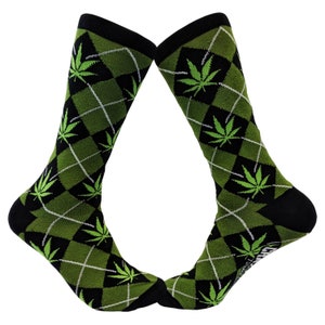 May include: A pair of black and green socks with a diamond pattern and green marijuana leaf designs.