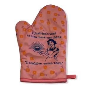 May include: A pink oven mitt featuring an orange floral pattern and a dark blue graphic of a person holding a plate with a burger. The text reads: I just don't want to look back and think I could've eaten that. It has a hanging loop.