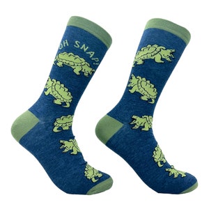 May include: A pair of blue socks with a green cuff. The socks feature a repeated pattern of green snapping turtles with the text "OH SNAP!" on one sock.