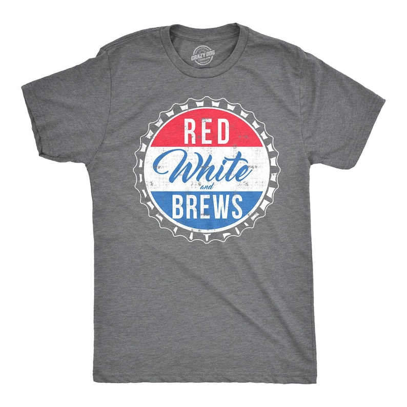 May include: A heather grey t-shirt with a distressed red, white, and blue bottle cap design. The text on the bottle cap reads "Red White and Brews".