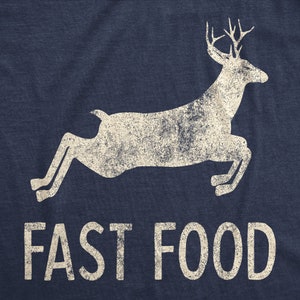 May include: Navy blue t-shirt with a distressed white graphic of a leaping deer and the words "FAST FOOD" in a bold font. The design has a vintage, worn look.