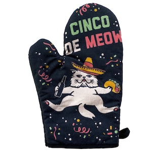 May include: Black oven mitt with a white cat wearing a sombrero and holding a bottle and a taco. The text on the mitt reads "Cinco de Meow".
