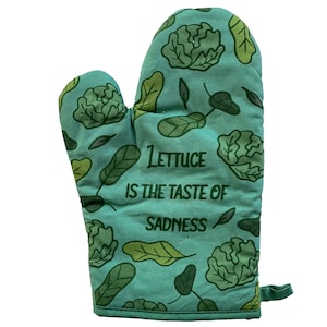 May include: Green oven mitt with a leafy pattern and the text "Lettuce is the taste of sadness".
