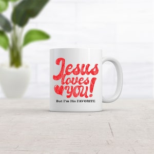 May include: White ceramic coffee mug with the text "Jesus loves you! But I'm His FAVORITE" in red and black lettering. The mug has a red heart with a black outline.
