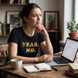 May include: A black short-sleeved t-shirt featuring the text YEAH, NO. printed in a distressed yellow font across the chest. The garment has a crew neckline and a standard fit, constructed from a solid-colored fabric with visible texture.
