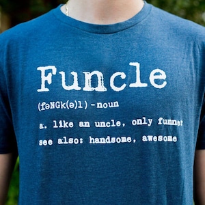 May include: A heathered blue short-sleeve t-shirt featuring white screen-printed text that reads: Funcle (fəNGk(ə)l) - noun a. like an uncle, only funner; see also: handsome, awesome. The shirt has a crew neckline and a standard fit.