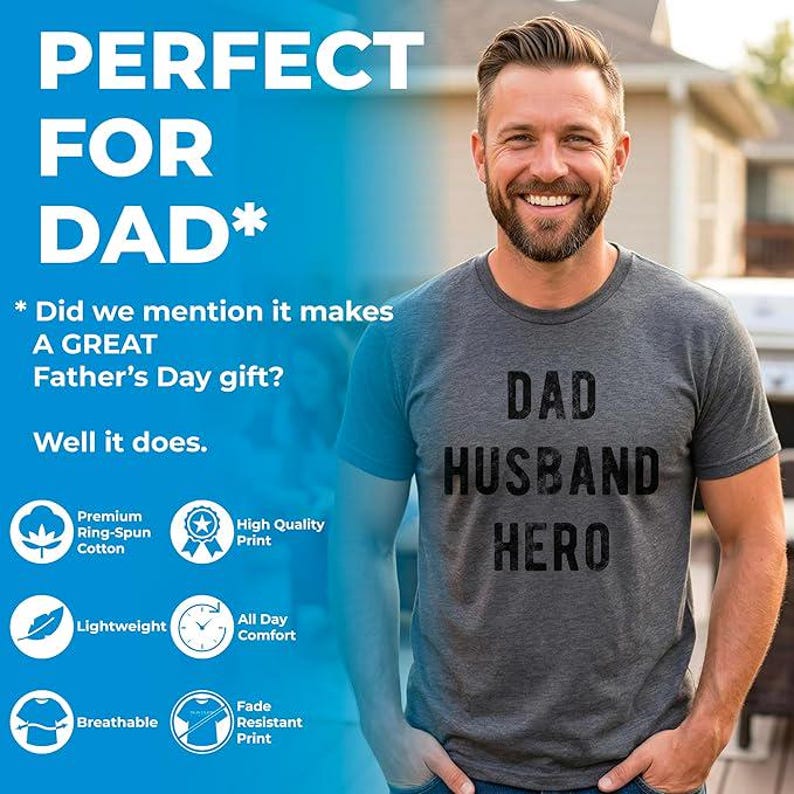 May include: A gray t-shirt with the words "DAD HUSBAND HERO" printed in black. The image also includes text that says "PERFECT FOR DAD" and "Did we mention it makes A GREAT Father's Day gift?" The shirt is made of premium ring-spun cotton.