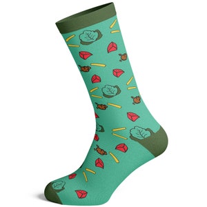May include: A pair of teal blue socks with a green and red pattern of lettuce, french fries, and red meat. The socks have a green cuff.