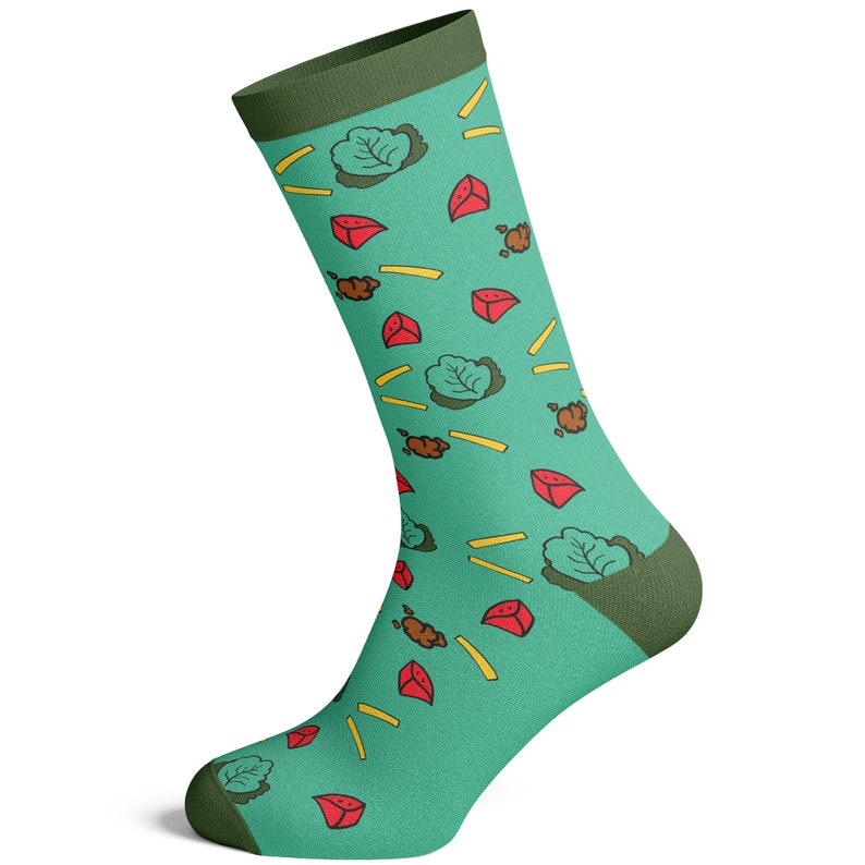 May include: A pair of teal blue socks with a green and red pattern of lettuce, french fries, and red meat. The socks have a green cuff.