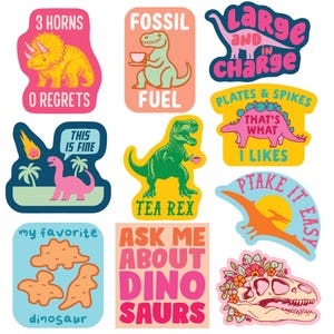 May include: A collection of colorful dinosaur-themed stickers. Designs include a triceratops, a T-Rex with a teacup, and a dinosaur skeleton with floral accents. Text includes "3 Horns, 0 Regrets", "Fossil Fuel", and "Ask Me About Dino Saurs".