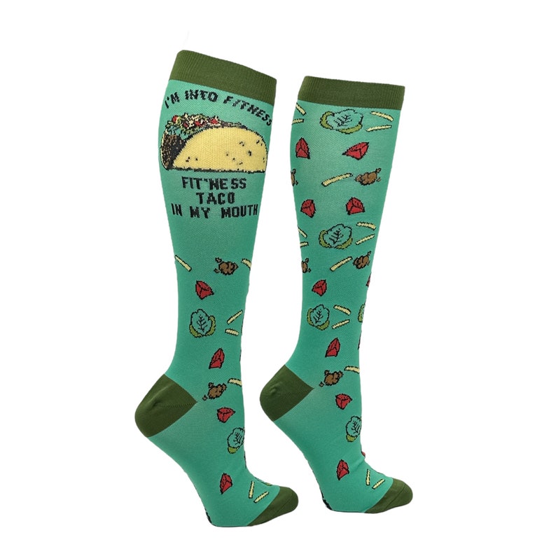 May include: A pair of green knee-high socks with a taco graphic and the text "I'm into fitness. Fitness taco in my mouth."