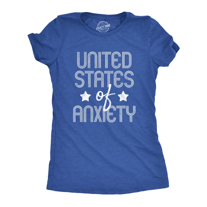 May include: A blue t-shirt with the text "UNITED STATES of ANXIETY" in white, with two star graphics. The shirt is a crew neck style.