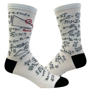 May include: A pair of light gray crew socks featuring a black mathematical print with various equations, formulas, and a geometry problem labeled 4. Find x with 48 meters and 26 meters, plus the red text found, with solid black heels and toes.