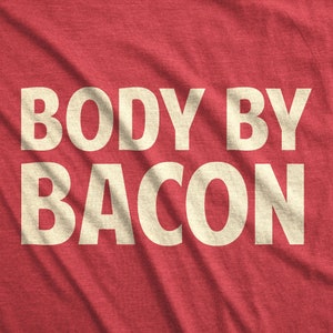 May include: Red t-shirt with the text "BODY BY BACON" in white.