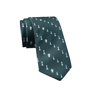 May include: A folded teal necktie with a repeating pattern of white chess pieces. The tie is made of a smooth fabric and is suitable for formal or business attire. The chess pieces include pawns, rooks, knights, bishops, a queen, and a king.
