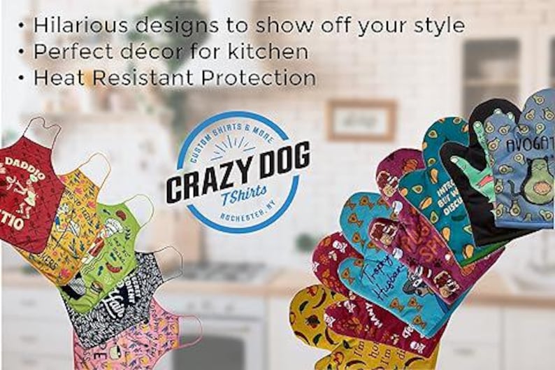 May include: A set of colorful oven mitts and kitchen aprons with humorous designs and text. The mitts and aprons feature various designs, including avocados, skulls, and text like "Intriguing but not Discussing". The text "Crazy Dog T-Shirts Rochester NY" is visible in the center of the image.