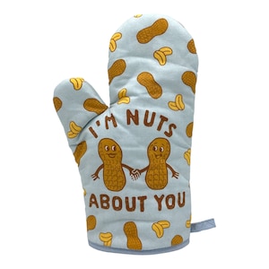 Könnte beinhalten: Ein hellblauer Topflappen mit einem Erdnussdesign und dem Text "I'm nuts about you".