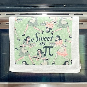 May include: A white kitchen towel with a repeating pattern of women in vintage dresses holding pies against a light green background featuring the mathematical symbol pi. The center text reads Sweet as π in a black script and serif font combination.