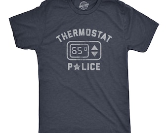 May include: A dark heather navy blue short-sleeve t-shirt featuring a distressed white graphic print. The design includes the text THERMOSTAT POLICE, a digital thermostat icon displaying 65 degrees, and a star replacing the letter O in POLICE.