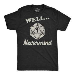 May include: Black t-shirt with the text "WELL... Nevermind" in white, along with a white, geometric die graphic with the number 1. The shirt is a crew neck and appears to be made of cotton.
