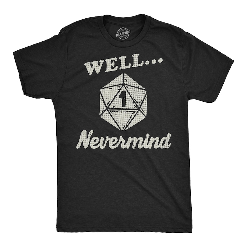 May include: Black t-shirt with the text "WELL... Nevermind" in white, along with a white, geometric die graphic with the number 1. The shirt is a crew neck and appears to be made of cotton.