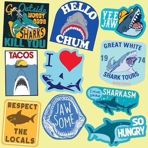 May include: A collection of colorful stickers featuring sharks, tacos, and other ocean-themed designs. The stickers have various slogans, including "Go Outside Worst Case Sharks Kill You", "Hello Chum", "Yee Jaw", "Great White Shark Tours Amity Island", "I Love Sharks", "Respect The Locals", "Jaw Some", "Sharkasm", and "So Hungry".