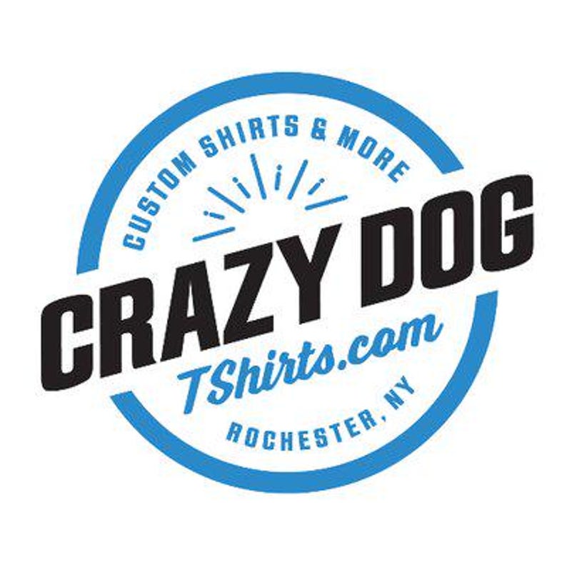 May include: Blue and white circular logo with the text "Custom Shirts & More" and "Crazy Dog" in black. The logo also includes the text "TShirts.com" and "Rochester, NY".