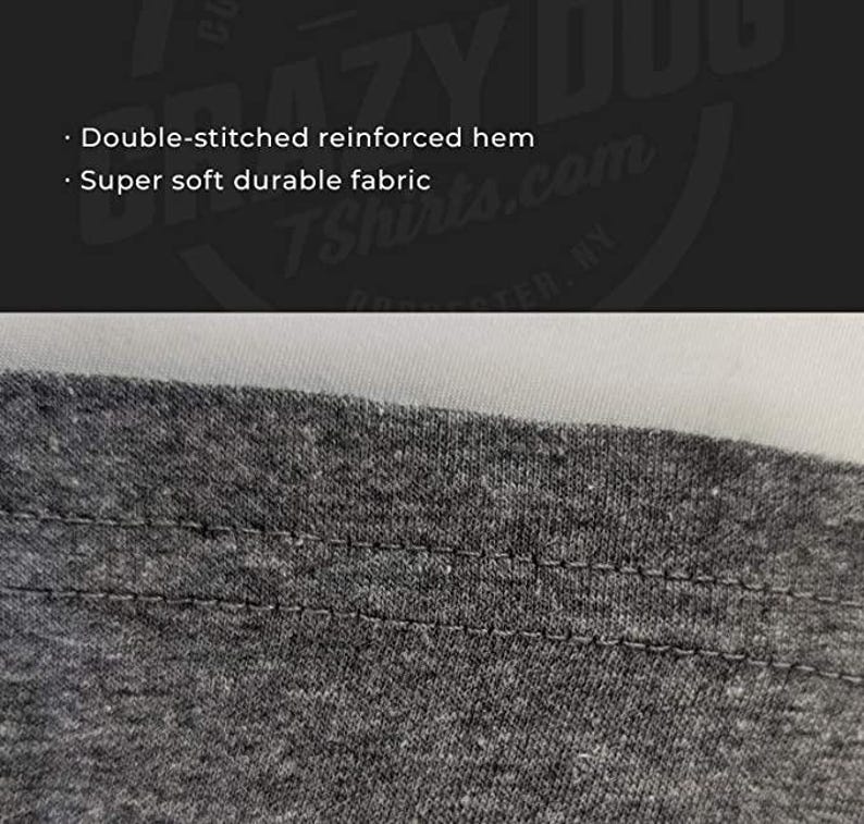 May include: Close-up of a gray t-shirt hem with double-stitched reinforcement. The fabric is a soft, durable material. The image also includes the text "Double-stitched reinforced hem" and "Super soft durable fabric".