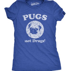 May include: A blue t-shirt with a white distressed graphic that says "PUGS not Drugs!" with a white circle around a pug's face.