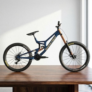 May include: A blue Santa Cruz V10 mountain bike with black tires and a black seat. The bike has gold lettering and accents, and is displayed on a wooden table. The tires have the word "MAXXIS" in yellow.