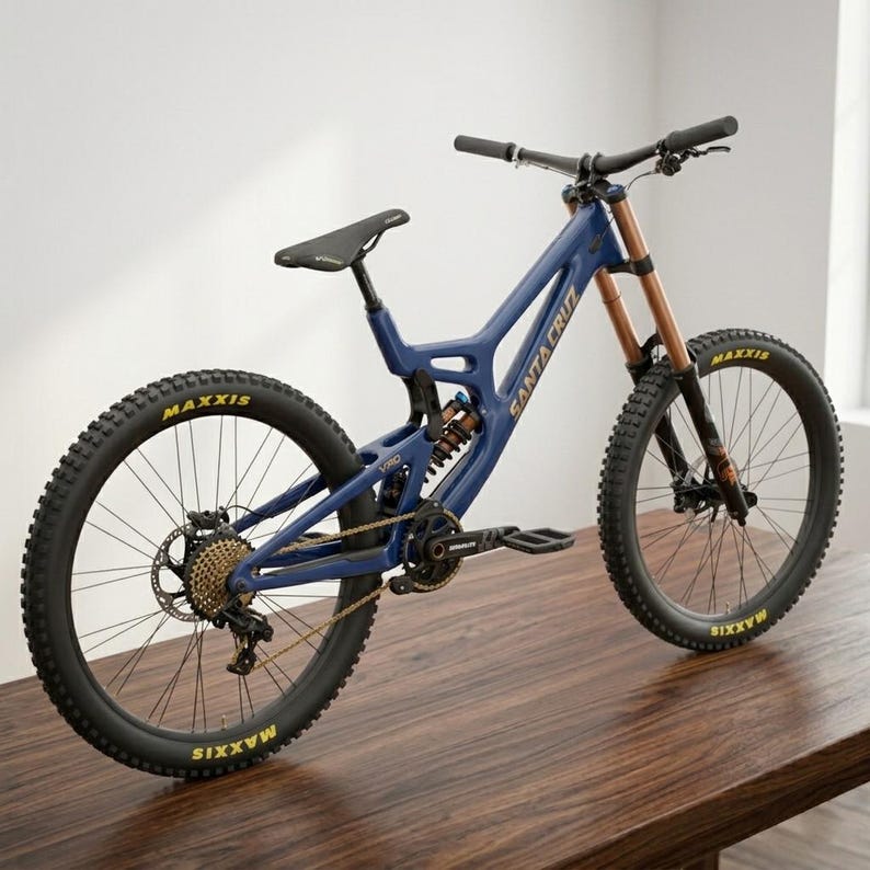 May include: A blue mountain bike with the brand name "Santa Cruz" in white lettering. The bike has black tires with "Maxxis" in yellow, a black seat, and gold chain. The front suspension is a copper color.