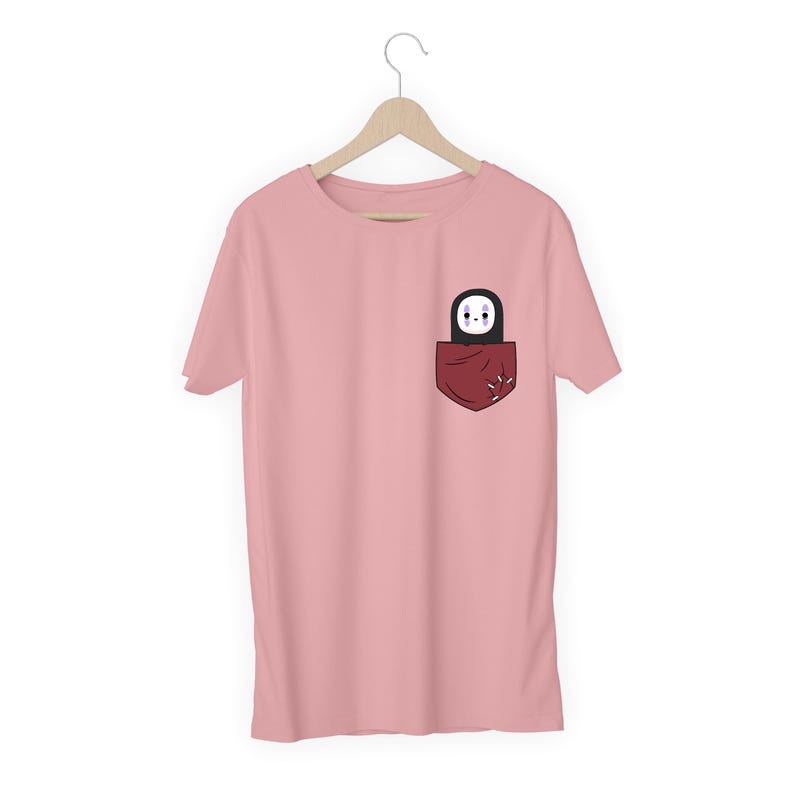 Pu&ograve; includere: T-shirt rosa chiaro con tasca rossa scuro. La tasca contiene un personaggio dei cartoni animati in bianco e nero. Il design del personaggio &egrave; semplice.