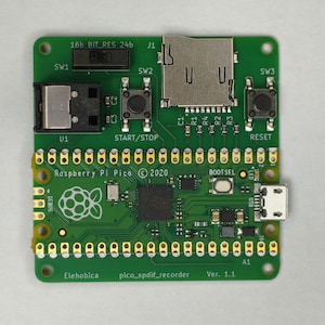 May include: A green printed circuit board labelled Elehobica pico_spdif_recorder Ver. 1.1 featuring a Raspberry Pi Pico, a micro SD card slot, three black push buttons labelled SW1, SW2, and SW3, a micro USB port, and various electronic components.