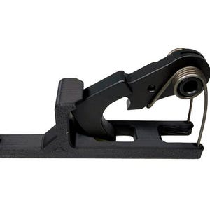 May include: A black metal component featuring a spring and a curved lever. The component has a rectangular base with a hole and a hook-like structure. The spring is silver and wraps around a cylindrical part.