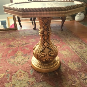 May include: Octagonal gold-painted table with a carved wooden base and a rope-like trim around the top edge.