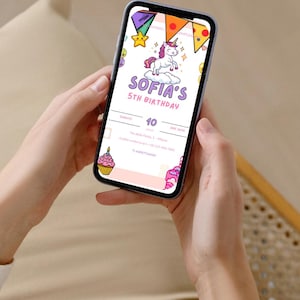 May include: A smartphone screen shows a vibrant birthday invitation. The design includes a unicorn, the text "SOFIA'S 5TH BIRTHDAY", and other festive graphics. The phone is held in someone's hands.