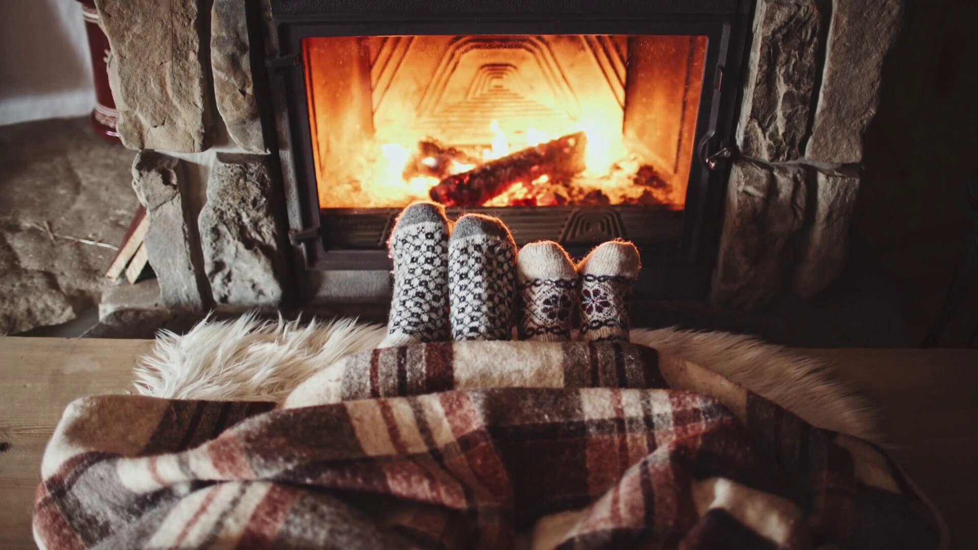 fireplace cozy fire warm blanket winter couple sitting socks feet woman shutterstock under 4k nights cabin warming fireplaces footage weather