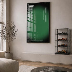 May include: A vertical rectangular framed wall art piece featuring a deep green gradient background with the text Aston Martin Aramco AMR25 printed in small white letters at the bottom center, encased in a thin black frame.