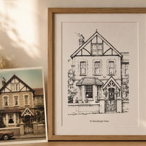 May include: A framed black and white ink line drawing of a house with a gabled roof and a front gate, featuring the text 15 Woodleigh Park at the bottom. Beside it sits a colour photograph of the same house, showing a car parked in front.