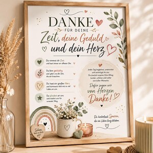May include: A framed wall art print featuring German text that reads DANKE FÜR DEINE Zeit, deine Geduld und dein Herz. The design includes botanical illustrations, a rainbow, heart icons, and a circular text block, all set against a white background.
