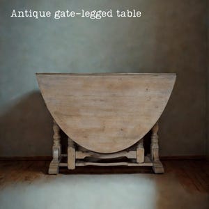 May include: An antique gate-legged table with a light wood finish. The table has a semi-circular top and ornate legs. The text "Antique gate-legged table" is displayed at the top of the image.