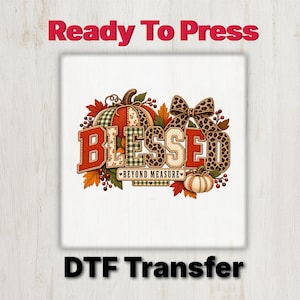 May include: A DTF transfer featuring the text BLESSED BEYOND MEASURE in a mix of red, green plaid, and leopard print patterns. The design includes pumpkins, autumn leaves, berries, and a large leopard print bow on a white background.