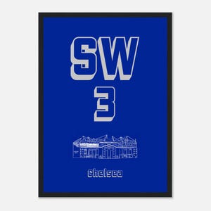 May include: A framed print with a blue background features the text "SW 3" in white, with a white architectural illustration below and the word "Chelsea" at the bottom. The print is in a black frame.