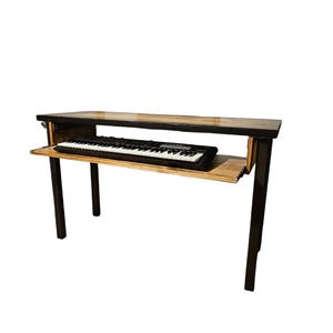 May include: A wooden table with black metal legs and a pull-out shelf for a keyboard. The table is made of reclaimed wood and has a natural finish.