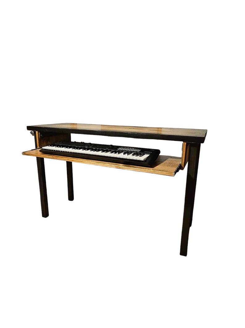 May include: A wooden table with black metal legs and a pull-out shelf for a keyboard. The table is made of reclaimed wood and has a natural finish.