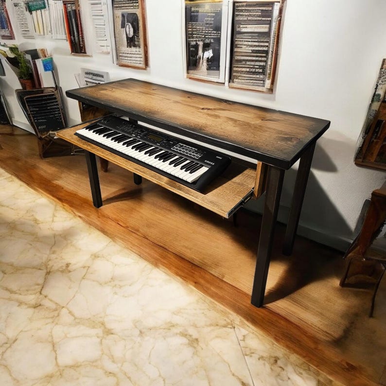 May include: A wooden table with a black metal frame and a pull-out shelf. A black keyboard is on the shelf. The table is in a room with a wooden floor and white walls.