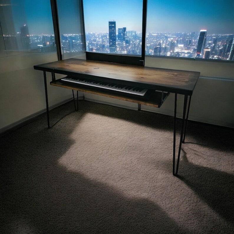 May include: A black metal desk with a wooden top and a pull-out keyboard tray. The desk is in a room with a large window overlooking a city skyline.